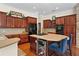 Functional kitchen island featuring a cooktop and convenient beverage center at 2902 Big Cypress Way, Wesley Chapel, FL 33544