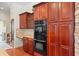 Gourmet kitchen featuring built-in double ovens and ample cabinet storage at 2902 Big Cypress Way, Wesley Chapel, FL 33544