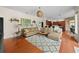 Spacious living room featuring hardwood floors, ample seating, and access to the kitchen at 2902 Big Cypress Way, Wesley Chapel, FL 33544