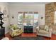 Bright living room with stone accent wall and views of the pool at 2902 Big Cypress Way, Wesley Chapel, FL 33544