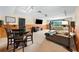 Open living room features plush seating, a dining table, and a wall-mounted television at 2902 Big Cypress Way, Wesley Chapel, FL 33544