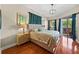 Bright main bedroom with hardwood floors, a sliding glass door to the outside, and an ensuite bath at 2902 Big Cypress Way, Wesley Chapel, FL 33544
