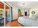 Large main bedroom with hardwood floors and a sliding glass door leading to a patio at 2902 Big Cypress Way, Wesley Chapel, FL 33544