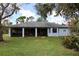 Home features a screened porch, expansive backyard, and fire pit at 320 Yule St, Port Charlotte, FL 33953