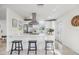 Bright kitchen featuring stainless steel appliances, white cabinetry, and a large island with barstool seating at 36846 Jefferson Ave, Dade City, FL 33523