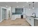 White kitchen with quartz countertops, stainless steel appliances, and blue tile at 3907 Kristin Pl, Valrico, FL 33596