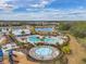 Community pool area with splash pad and lounge chairs at 5125 Autumn Ridge Dr, Wesley Chapel, FL 33545