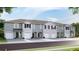 New townhome community with attached garages and neutral color palette at 515 Mangrove Shade Cir, Apollo Beach, FL 33572