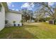 Landscaped backyard with storage shed and concrete patio at 524 S Grosse Ave, Tarpon Springs, FL 34689
