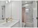 Updated bathroom with a single vanity and marble shower/tub combo at 524 S Grosse Ave, Tarpon Springs, FL 34689