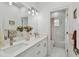 Double vanity bathroom with marble tile and updated fixtures at 524 S Grosse Ave, Tarpon Springs, FL 34689