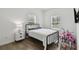 Bright bedroom with metal bed frame and wood-look floors at 524 S Grosse Ave, Tarpon Springs, FL 34689