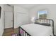 Spacious bedroom with a metal bed frame and ample closet space at 524 S Grosse Ave, Tarpon Springs, FL 34689