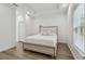 Light and airy bedroom with a queen bed at 524 S Grosse Ave, Tarpon Springs, FL 34689
