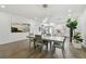 Modern dining area with a large table, and adjacent kitchen at 524 S Grosse Ave, Tarpon Springs, FL 34689