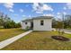 Front view of the house with walkway and landscaping at 524 S Grosse Ave, Tarpon Springs, FL 34689
