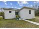 Side view of a modern white house with walkway and landscaping at 524 S Grosse Ave, Tarpon Springs, FL 34689