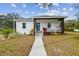 Newly built home with modern facade, landscaped yard, and walkway at 524 S Grosse Ave, Tarpon Springs, FL 34689