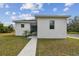 Modern white house with walkway, landscaping, and teal pots at 524 S Grosse Ave, Tarpon Springs, FL 34689