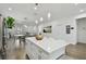 Open concept kitchen with white cabinets, island and stainless steel appliances at 524 S Grosse Ave, Tarpon Springs, FL 34689