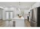 Modern kitchen with white cabinets, stainless steel appliances and an island at 524 S Grosse Ave, Tarpon Springs, FL 34689
