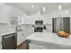 Modern kitchen with white cabinets, stainless steel appliances and an island at 524 S Grosse Ave, Tarpon Springs, FL 34689