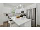 Spacious kitchen with white cabinets, stainless steel appliances, and an expansive island at 524 S Grosse Ave, Tarpon Springs, FL 34689