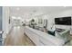 Open concept living space with large sectional sofa and flat-screen TV at 524 S Grosse Ave, Tarpon Springs, FL 34689