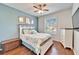 Bedroom with a queen-size bed, dresser, and window with shutters at 5527 Sunset Falls Dr, Apollo Beach, FL 33572