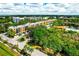 Aerial view of a condo building with pool and lake at 5849 Park N St # 201, St Petersburg, FL 33709