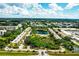 Aerial view of condo community with a pool, tennis court, and a lake at 5849 Park N St # 201, St Petersburg, FL 33709