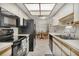 Kitchen with breakfast nook and black appliances at 5849 Park N St # 201, St Petersburg, FL 33709