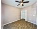 Bedroom with ceiling fan and wood-look flooring at 6022 Portsdale Pl # 102, Riverview, FL 33578