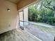 Screened patio with wood-look flooring and access to backyard at 6022 Portsdale Pl # 102, Riverview, FL 33578