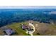Stunning aerial view of a sprawling home on a large lot with mature trees at 6367 Foxbrook Trl, Parrish, FL 34219