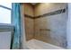 Bathroom featuring decorative tile accent stripe, shower and tub combination, and chrome grab bar at 6367 Foxbrook Trl, Parrish, FL 34219