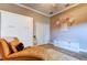 Bedroom boasts stylish Murphy bed, tufted chaise, recessed lighting, and tasteful decor at 6367 Foxbrook Trl, Parrish, FL 34219