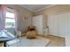 Charming bedroom with large window, neutral walls, white trim, and light-colored furnishings at 6367 Foxbrook Trl, Parrish, FL 34219