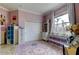 Charming purple bedroom with window, storage, and a unique colorful accent rug at 6367 Foxbrook Trl, Parrish, FL 34219