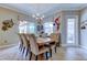Dining room with a large wood table, upholstered chairs, and natural lighting at 6367 Foxbrook Trl, Parrish, FL 34219