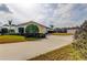 Long driveway leading to a well-maintained home and separate garage, enhanced by mature landscaping and lush greenery at 6367 Foxbrook Trl, Parrish, FL 34219