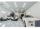 Showcase garage with several luxury classic cars on display with bright LED lighting highlighting this collector's dream at 6367 Foxbrook Trl, Parrish, FL 34219