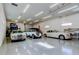 Showcase garage with several luxury classic cars on display with bright LED lighting highlighting this collector's dream at 6367 Foxbrook Trl, Parrish, FL 34219