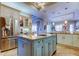 Kitchen with center island, granite counters, stainless steel appliances and custom cabinets at 6367 Foxbrook Trl, Parrish, FL 34219