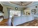 Spacious living room with hardwood floors, fireplace, and views of the outdoor pool at 6367 Foxbrook Trl, Parrish, FL 34219