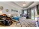 Beautifully decorated bedroom featuring tray ceilings, ensuite bathroom, and large glass patio doors at 6367 Foxbrook Trl, Parrish, FL 34219