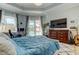 Bright and airy bedroom with a large window and sliding glass door to the pool area at 6367 Foxbrook Trl, Parrish, FL 34219
