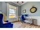 Cozy office with a large window, desk with monitors, and comfortable blue arm chair at 6367 Foxbrook Trl, Parrish, FL 34219