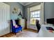 Bright home office with a stylish blue chair, modern desk, and beautiful window view at 6367 Foxbrook Trl, Parrish, FL 34219