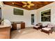 Charming outdoor space with a fully equipped kitchen, ceiling fan, and relaxing wicker furniture at 6367 Foxbrook Trl, Parrish, FL 34219